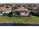 Backyard view with screened lanai, offering a private space with lush greenery and peaceful water views at 6560 Willowshire Way, Bradenton, FL 34212