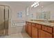 Bathroom featuring double sinks, granite countertop, shower, and a soaking tub at 6560 Willowshire Way, Bradenton, FL 34212