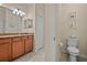 Comfortable bathroom with granite countertop and a toilet with decorative wall art at 6560 Willowshire Way, Bradenton, FL 34212