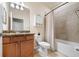 Well-lit bathroom featuring a vanity with granite countertop, toilet and shower with neutral tiling at 6560 Willowshire Way, Bradenton, FL 34212