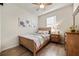 Cozy bedroom with wood-look floors, natural light, and neutral decor at 6560 Willowshire Way, Bradenton, FL 34212