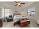 Bedroom with wood flooring, ceiling fan, and windows with blinds allowing natural light at 6560 Willowshire Way, Bradenton, FL 34212