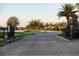 Gated entrance to community featuring lush landscaping, lake, and meticulously maintained streets at 6560 Willowshire Way, Bradenton, FL 34212