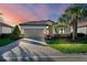 Charming home with brick paver driveway, two-car garage and a lush, tropical landscaped yard at 6560 Willowshire Way, Bradenton, FL 34212