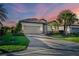 Charming home with brick paver driveway, two-car garage and a lush, tropical landscaped yard at 6560 Willowshire Way, Bradenton, FL 34212