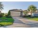 Charming home with brick paver driveway, two-car garage and a lush, tropical landscaped yard at 6560 Willowshire Way, Bradenton, FL 34212