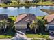 Beautiful waterfront home with tile roof, brick driveway, two-car garage and lush landscaping at 6560 Willowshire Way, Bradenton, FL 34212