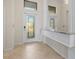 Inviting foyer showcasing tiled flooring and a decorative glass front door, with transom windows above at 6560 Willowshire Way, Bradenton, FL 34212