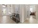 Inviting foyer with bench seating, tile flooring, and natural light from the entry door at 6560 Willowshire Way, Bradenton, FL 34212