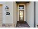 Elegant glass-panel front door with brick facade and pavers, and elegant wall lantern at 6560 Willowshire Way, Bradenton, FL 34212