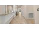 Bright hallway featuring neutral tile flooring and a built-in ledge with granite countertop at 6560 Willowshire Way, Bradenton, FL 34212