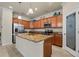 Kitchen showcasing a large island with a sink, stainless steel appliances, granite countertops, and a pantry at 6560 Willowshire Way, Bradenton, FL 34212