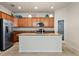 Kitchen featuring stainless steel appliances, granite counters, a center island, and a door to the pantry at 6560 Willowshire Way, Bradenton, FL 34212