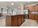 Open plan kitchen featuring a center island, stainless steel appliances, and dark wood cabinets at 6560 Willowshire Way, Bradenton, FL 34212