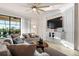 Comfortable living room with a modern ceiling fan, plush seating, and a large window overlooking the water at 6560 Willowshire Way, Bradenton, FL 34212