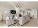 Spacious open-concept living room with plush sofas, modern fixtures, and access to the dining area at 6560 Willowshire Way, Bradenton, FL 34212