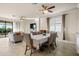 Open floor plan featuring dining area, and living room with large window overlooking the water view at 6560 Willowshire Way, Bradenton, FL 34212