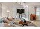 Cozy living room featuring a comfortable seating area, a flat screen TV, and a decorative shelving unit at 6560 Willowshire Way, Bradenton, FL 34212