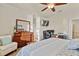 Spacious primary bedroom features wood floors, a ceiling fan, and a work area with two computer monitors at 6560 Willowshire Way, Bradenton, FL 34212