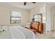 Comfortable primary bedroom with wood floors, a ceiling fan, and windows with blinds at 6560 Willowshire Way, Bradenton, FL 34212