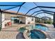 Inviting screened-in pool area with connected spa and brick paver patio, perfect for relaxation and entertainment at 6560 Willowshire Way, Bradenton, FL 34212