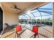 Relaxing screened-in pool and patio area with a view of the lake; ideal for outdoor entertaining at 6560 Willowshire Way, Bradenton, FL 34212
