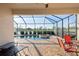 Covered patio with screened-in pool, spa, and view of the pond, perfect for outdoor enjoyment at 6560 Willowshire Way, Bradenton, FL 34212