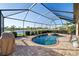 Relaxing screened-in pool area with a spillover spa and serene lake views, ideal for outdoor living at 6560 Willowshire Way, Bradenton, FL 34212