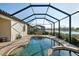 Enclosed pool and spa, perfect for relaxation, with a view of the nearby serene lake at 6560 Willowshire Way, Bradenton, FL 34212
