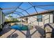 A screened-in pool and paver patio offer a relaxing outdoor space for enjoying the Florida sunshine at 6560 Willowshire Way, Bradenton, FL 34212
