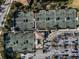 Aerial view of the tennis courts and parking lot with cars parked in dedicated spots at 6560 Willowshire Way, Bradenton, FL 34212
