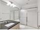 Well-lit bathroom with shower, tiled walls, and modern vanity at 6639 Pineview Ter # 6639, Bradenton, FL 34203