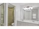 Clean bathroom with double vanity, large mirror, shower, and frosted glass doors at 6639 Pineview Ter # 6639, Bradenton, FL 34203
