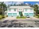 Stylish condo complex showcases vibrant turquoise doors and lush landscaping at 6639 Pineview Ter # 6639, Bradenton, FL 34203