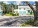Stylish condo complex showcases vibrant turquoise doors, white facade, and green lawn at 6639 Pineview Ter # 6639, Bradenton, FL 34203