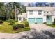 Charming two-story townhouse with light blue trim, a two-car garage, and a well-manicured lawn at 6639 Pineview Ter # 6639, Bradenton, FL 34203