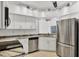 Bright kitchen with stainless steel refrigerator, marbled countertops, and modern lighting at 6639 Pineview Ter # 6639, Bradenton, FL 34203