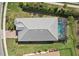 Aerial view of the house showcasing the pool, well-maintained roof, and landscaping on a sunny day at 7140 Woodville Cv, Bradenton, FL 34202