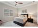 Bedroom featuring a bed, ceiling fan, and window with shutters at 7140 Woodville Cv, Bradenton, FL 34202