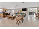 Bright and airy living room featuring tile floors, ceiling fan, and an open floor plan at 7262 Alafia Ridge Loop, Riverview, FL 33569