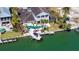 Aerial perspective of a waterfront home with a private boat lift and dock, showcasing its prime location and amenities at 732 Siesta Dr, Sarasota, FL 34242