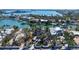 Stunning aerial view of a waterfront property surrounded by lush tropical landscaping and serene blue waters at 732 Siesta Dr, Sarasota, FL 34242