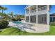 Backyard view featuring a beautiful pool and a covered outdoor seating area, creating a perfect entertainment space at 732 Siesta Dr, Sarasota, FL 34242