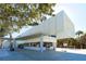 Modern white building serves as a beach cafe, offering refreshments and shade for beach visitors at 732 Siesta Dr, Sarasota, FL 34242