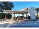 A covered pavilion at the beach with benches, picnic tables, and beach access at 732 Siesta Dr, Sarasota, FL 34242