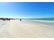 Expansive beach featuring soft sand, clear water, and a sunny sky, ideal for a leisurely stroll at 732 Siesta Dr, Sarasota, FL 34242