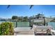 Dockside view of waterfront home with a private boat lift and dock, offering direct access to the water at 732 Siesta Dr, Sarasota, FL 34242