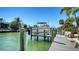 Private boat dock equipped with a boat lift, providing easy access for boating and water adventures at 732 Siesta Dr, Sarasota, FL 34242