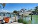 Waterfront property with a private dock and boat lift, offering convenient water access and boating opportunities at 732 Siesta Dr, Sarasota, FL 34242