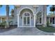 Close-up of a home's grand entrance, showcasing an arched doorway with detailed glass work at 732 Siesta Dr, Sarasota, FL 34242